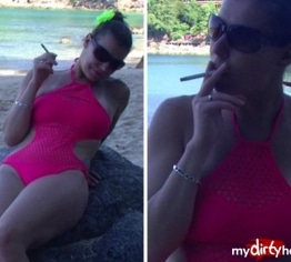 Smoking in red Swimsuit on the Beach